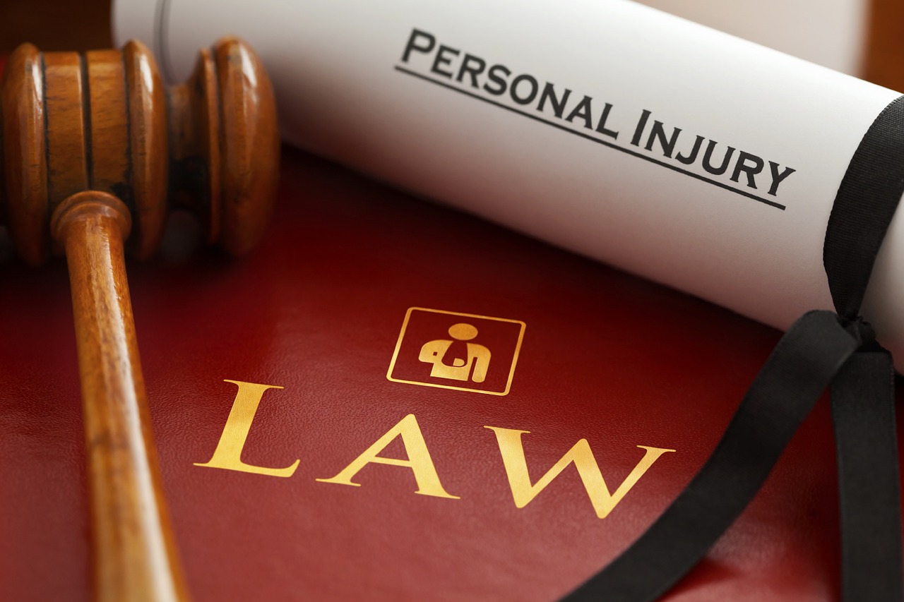 paper with personal injury text and gavel