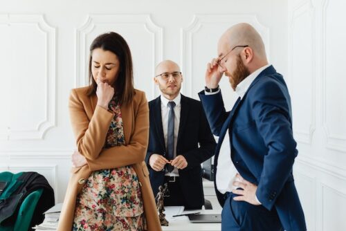 couple arguing in front of man