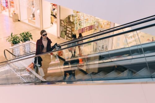 woman holding bags in shopping mall