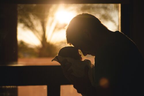 man holding baby