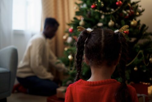 little girl in front of christmas tree