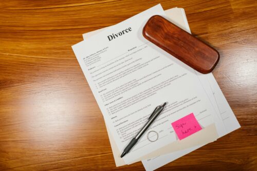 divorce papers, ring, and pen