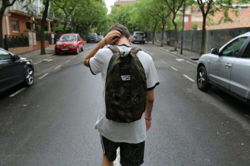 teenager walking with backpack on
