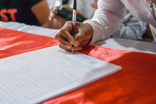 person signing paper